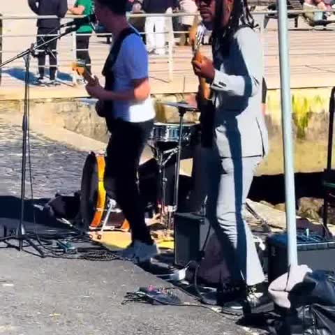 Street musicians playing by the water in Lisbon